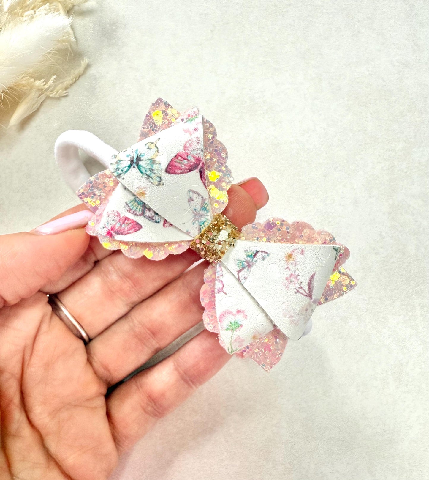 Pink butterfly baby headband on a soft nylon dainty headband for toddlers, babies up to adult