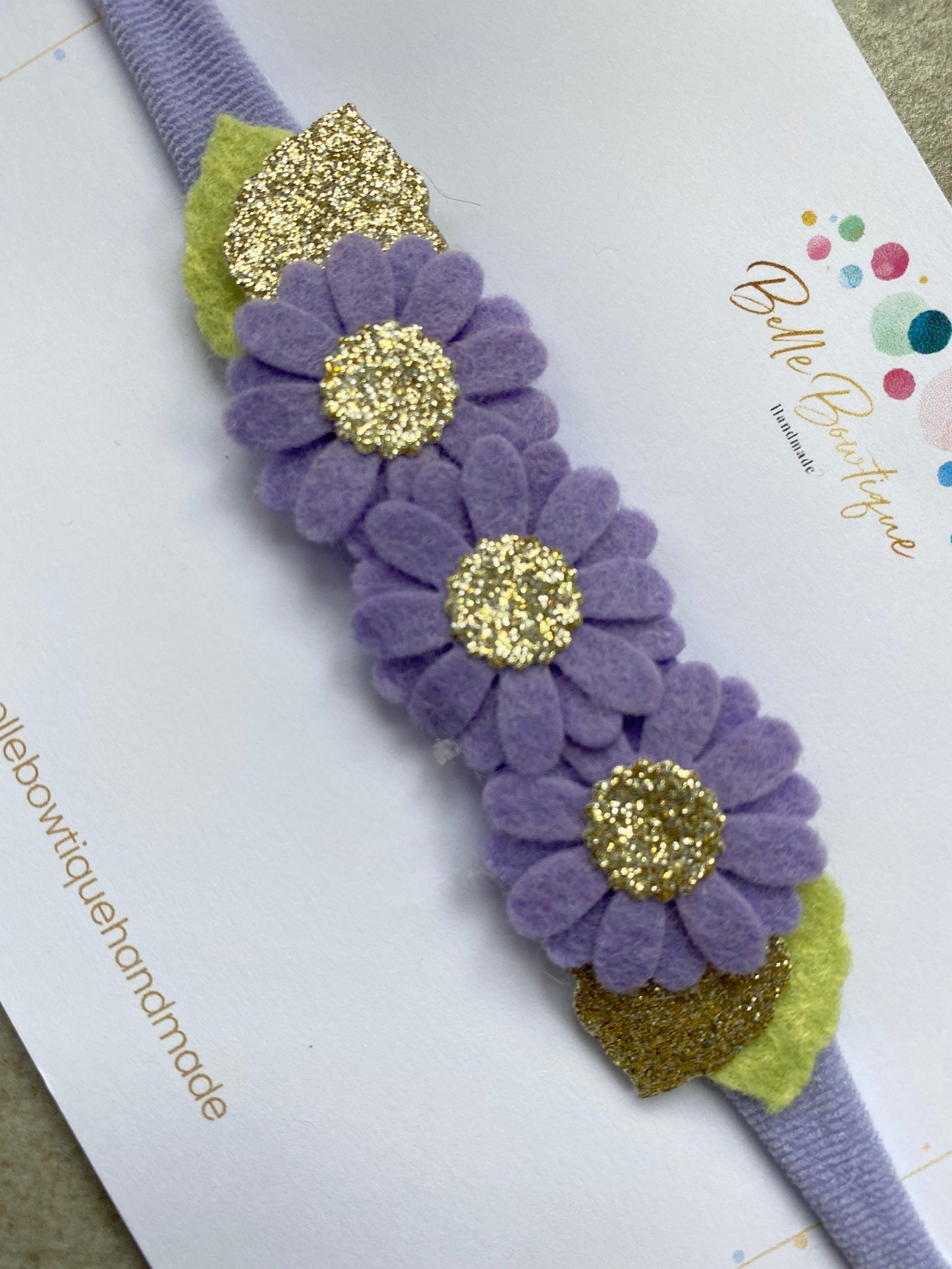 Purple daisy felt flower with gold sparkle centre