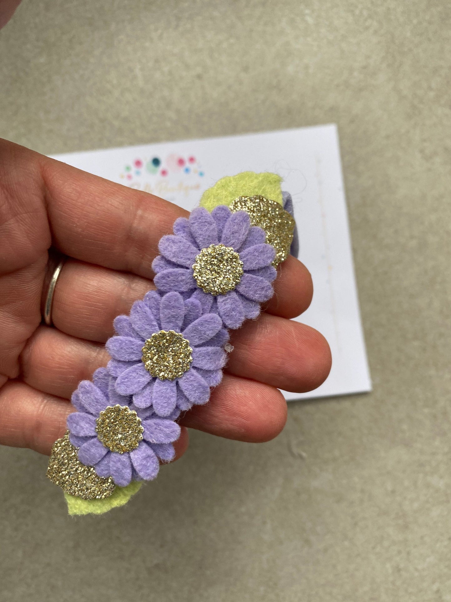 Purple daisy felt flower with gold sparkle centre