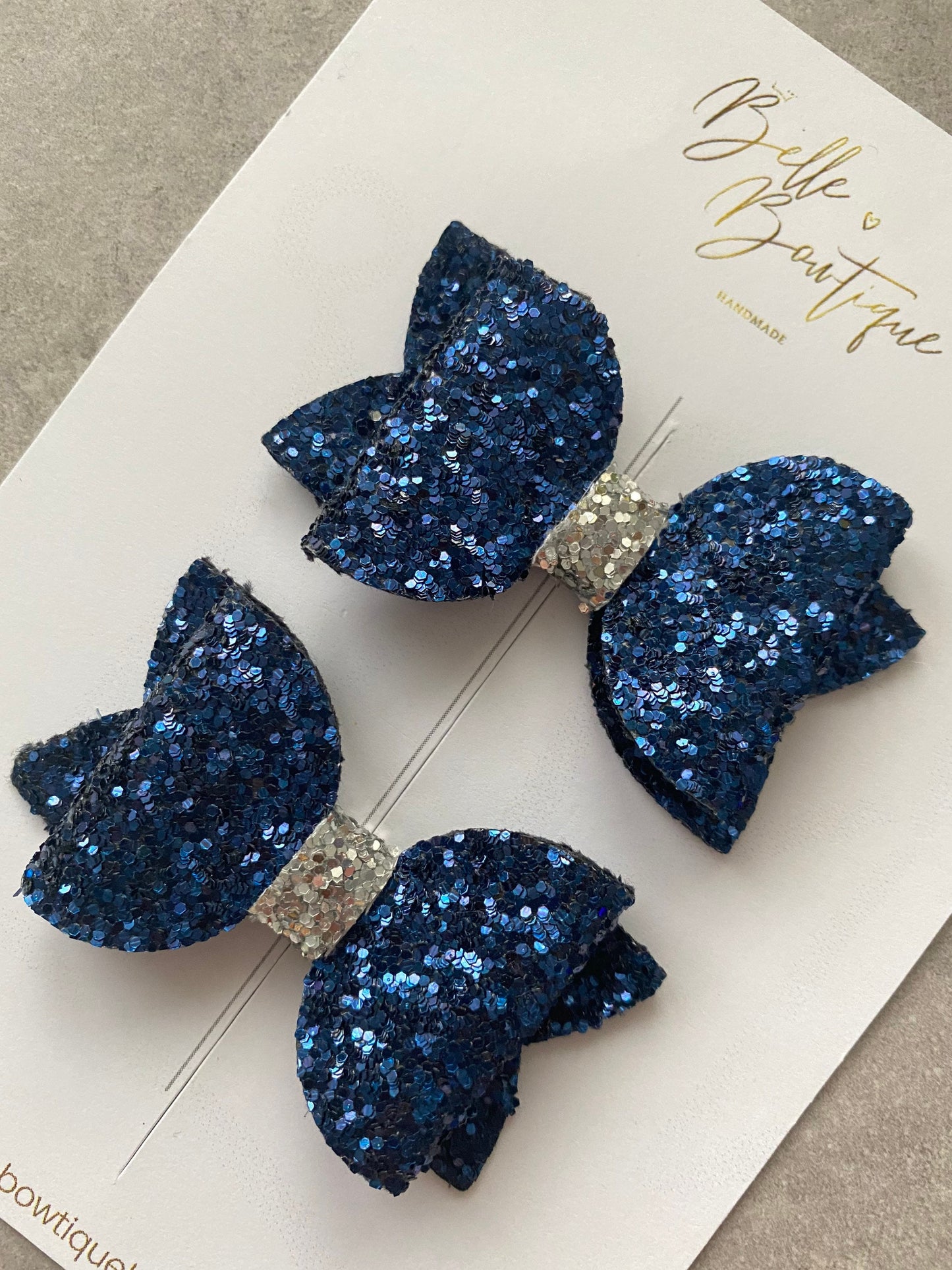 A Pair of Navy Blue and Silver Glitter Clips