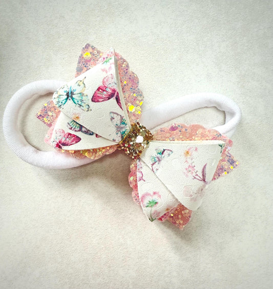 Pink butterfly baby headband on a soft nylon dainty headband for toddlers, babies up to adult